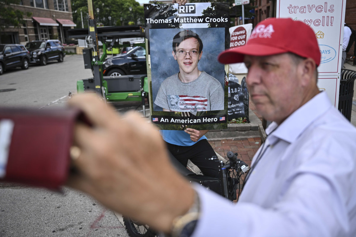 A man takes a selfie of a poster of Thomas Matthew Crooks, the 20-year-old who tried to assassinate Donald Trump. (AP)