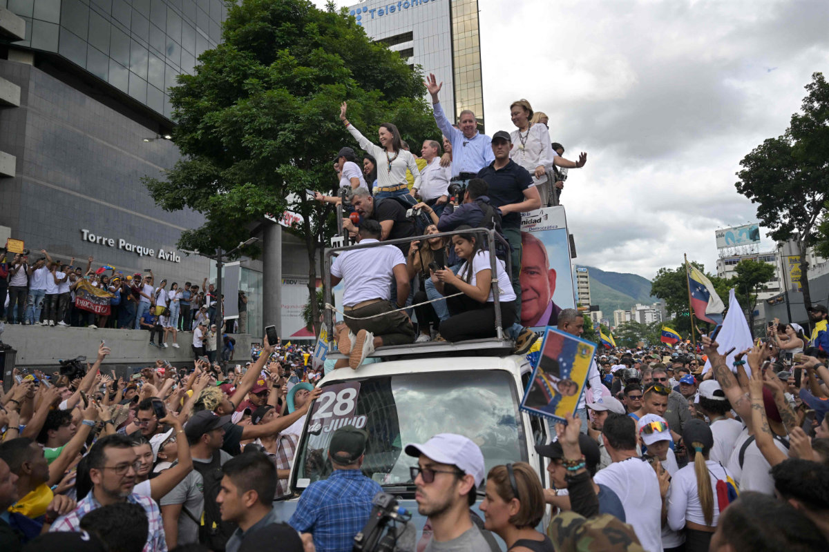 Venezuelan opposition leaders greet supporters during a rally in front of the UN office in Caracas on July 30, 2024. (AFP)