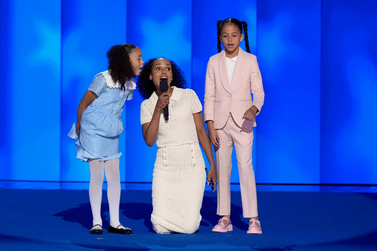 Kerry Washington, center, with grand-nieces of Vice President Kamala Harris Amara Ajagu, right, and Leela Ajagu, speak during the Democratic National Convention on Aug. 22, 2024, in Chicago. (AP Photo)