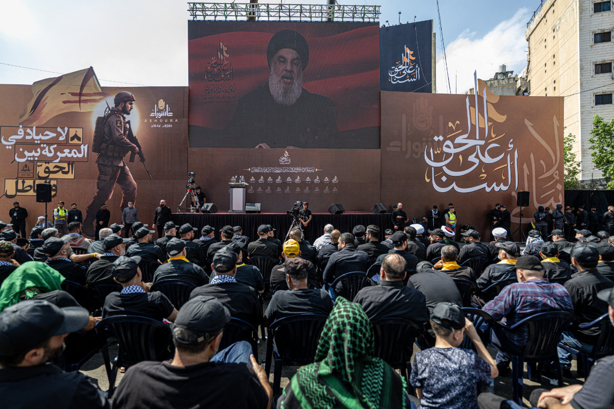 People watch a televised speech of Hezbollah chief Hasan Nasrallah in Beirut. (AFP/File)