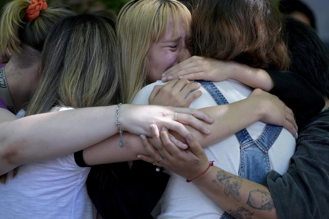 Fans of former One Direction singer Liam Payne grieve outside Casa Sur Hotel where the British pop singer fell to his death. (AP)