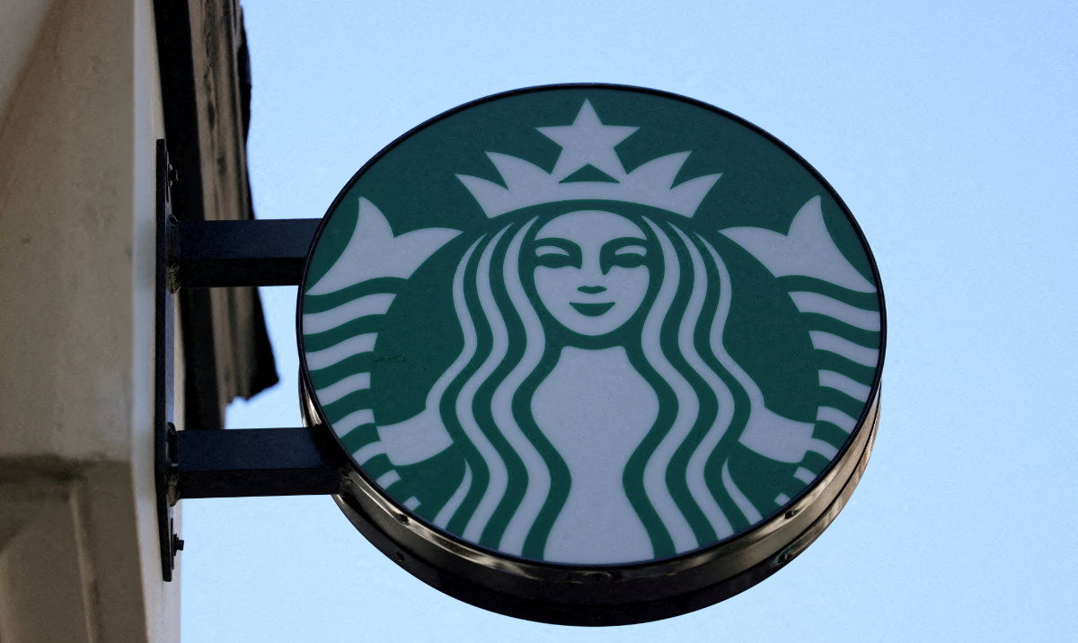 Starbucks logo is displayed above their cafe in London, Britain, August 13, 2024. (Reuters)