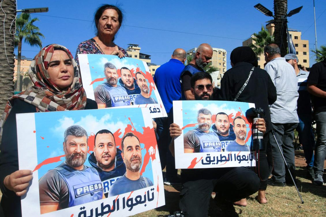 Media workers carrying posters bearing the pictures of Lebanese journalists, take part in a sit in, a day after they were killed in an Israeli strike in Hasbaya in southern Lebanon, in Sidon on October 26, 2024. (File/AFP)