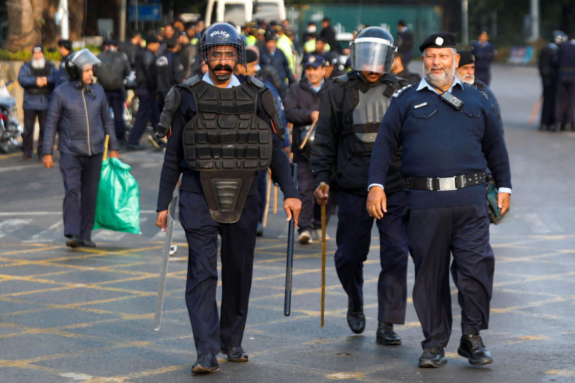 Police officers walk to guard a road to prevent an anti-government rally by supporters of the former Pakistani Prime Minister Imran Khan’s party Pakistan Tehreek-e-Insaf (PTI) in Islamabad, Pakistan.(REUTERS)