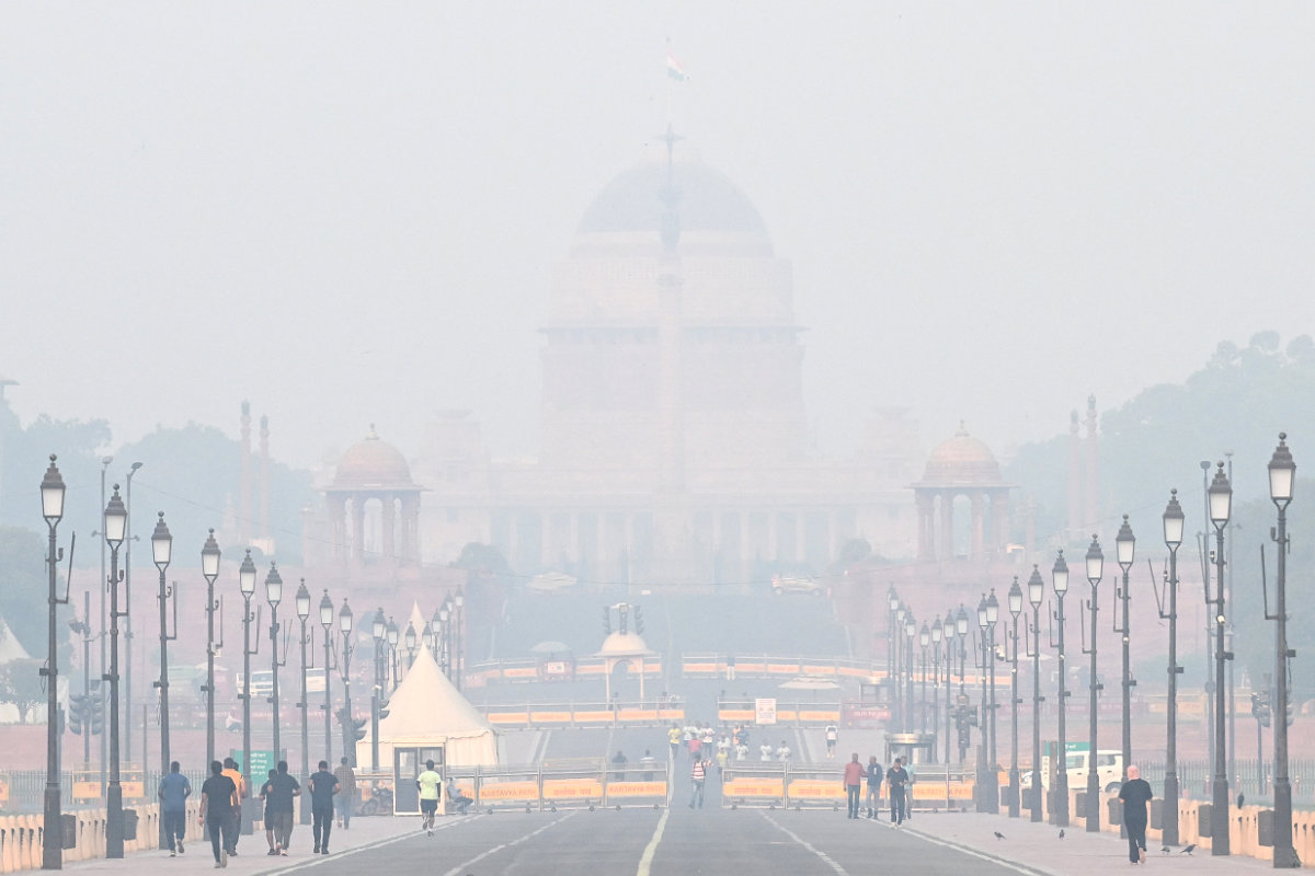 Pedestrians walk near the presidential palace Rashtrapati Bhavan in New Delhi on November 1, 2024 amid smoggy conditions. (AFP)