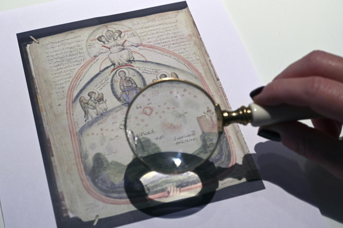 Christina Sotirakoglou a handwriting expert, observes Byzantine paintings based on photographs prints, at her office, in Thessaloniki, northern Greece, Saturday, Nov. 30, 2024. (AP)