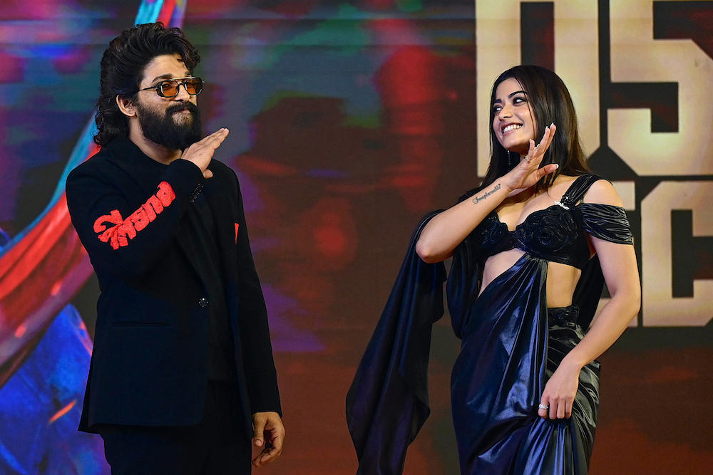 Indian actor Allu Arjun, left, and actress Rashmika Mandanna pose for photos as they attend a promotional event of their upcoming Indian film ‘Pushpa 2: The Rule’ in Mumbai on Nov. 29, 2024. (AFP)
