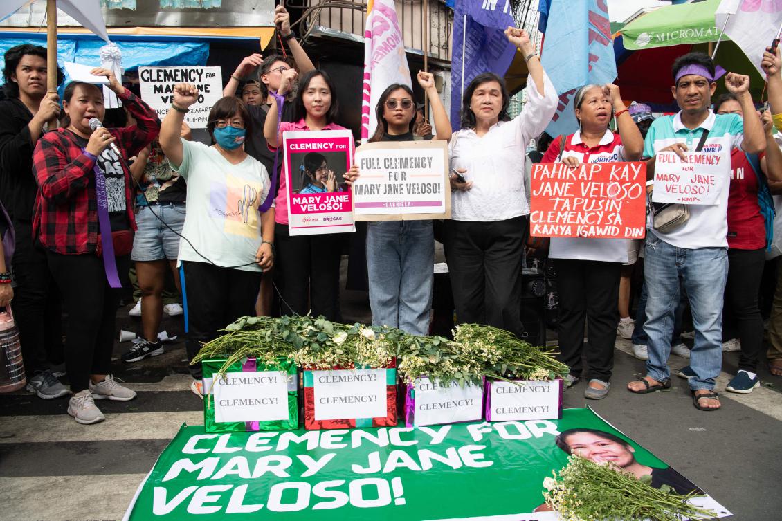 Protesters and supporters of Mary Jane Veloso raise their fists during a protest outside the prison facilities at the Correctional Institution for Women in Manila on December 18, 2024. (AFP)