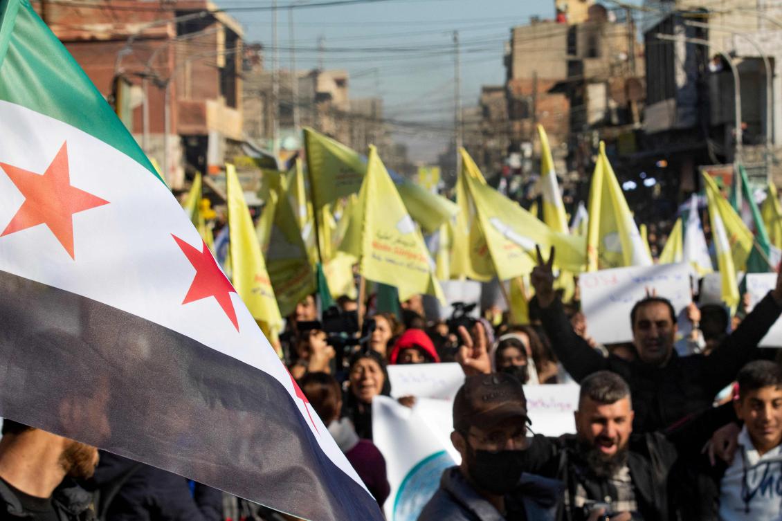 Syrian Kurds wave independence-era flags and flash the V for victory sign during a demonstration in support of the US-backed, Kurdish-led Syrian Democratic Forces in the northeastern city of Qamishli. (File/AFP)