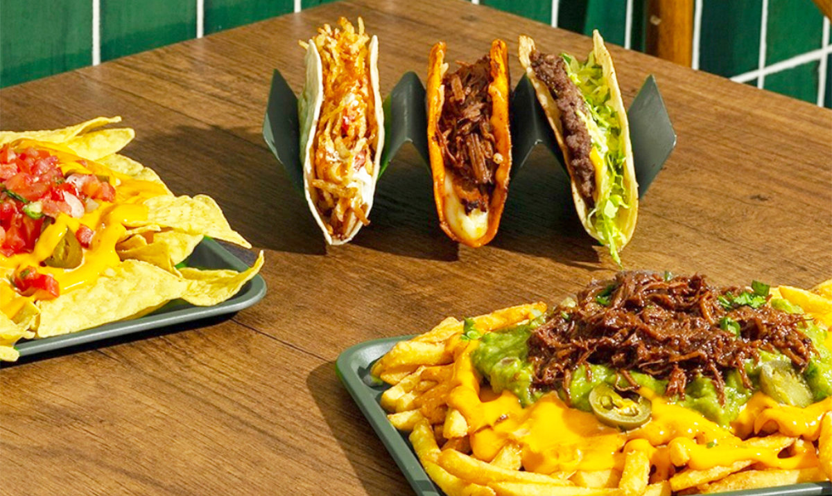 A delicious spread featuring the Taco Mix platter, loaded nachos, and cheesy fries, showcasing the variety of fresh and bold flavors at Just Taco. (Supplied)