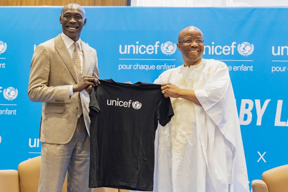 TikTok star Khaby Lame receives a T-shirt from UNICEF Regional Director for West and Central Africa Gilles Fagninou after being named UNICEF Goodwill Ambassador. (AP)