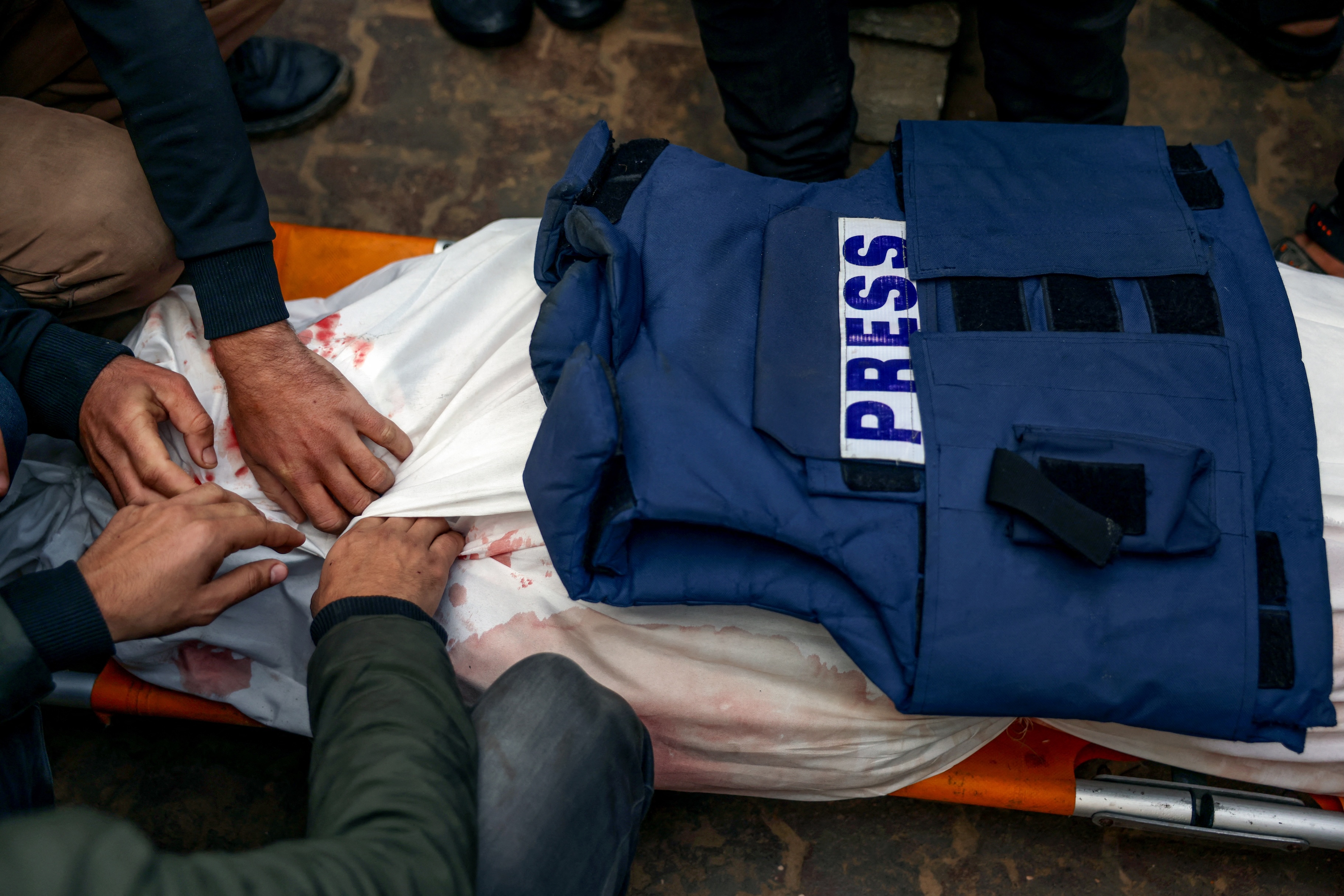 Mourners prepare for burial the body of Palestinian journalist Ahmed Al-Shayah after he was killed during an Israeli strike the previous night in Khan Yunis, at Nasser Hospital, in the southern Gaza Strip, Jan.16, 2025. (AFP)