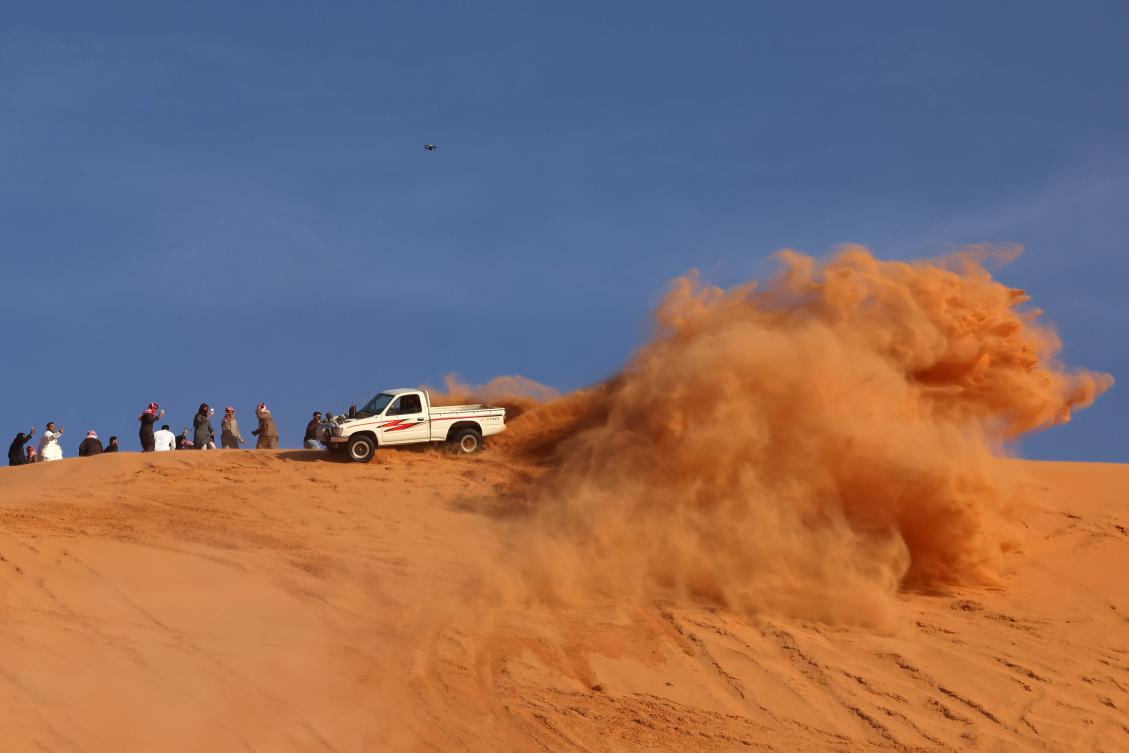 A Saudi driver drives his car up a dune in the Quseiba area, in the Az Zulfi desert on February 22, 2025. Every year through the end of April, droves of people flock to Zulfi, more than 200 kilometers northwest of Riyadh, where adrenaline-seeking motorists drive superpowered cars across steep dunes. (AFP)