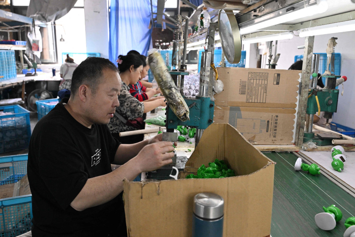 Employees work at a toy factory specializing in solar powered plastic gadgets in Yiwu, China’s eastern Zhejiang province on April 11, 2025. Its products are geared largely towards export -- a sector freshly menaced by Donald Trump's roiling of the global economy and increasingly brutal China tariffs. (AFP)