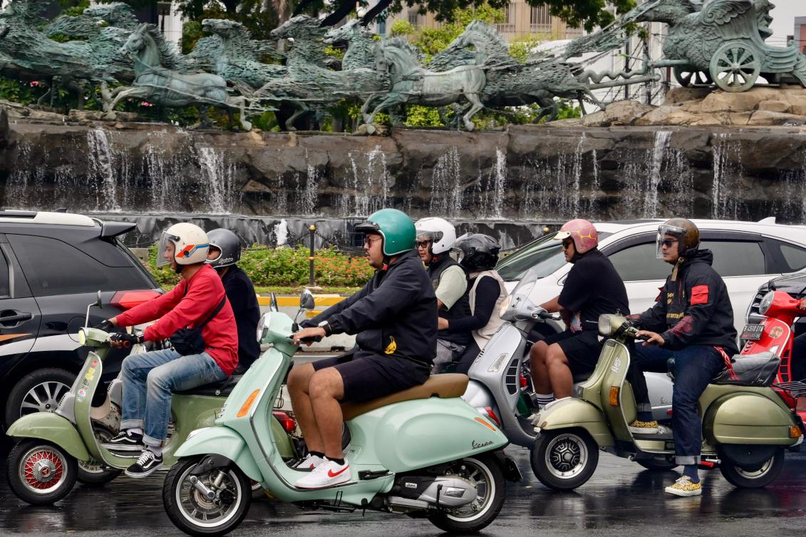 Above, Vespa enthusiasts riding along a road in Jakarta. (AFP)