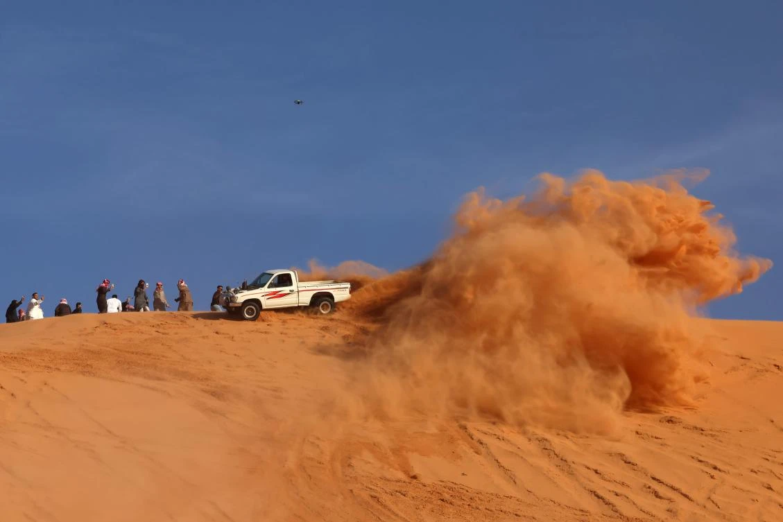 A Saudi driver drives his car up a dune in the Quseiba area, in the Az Zulfi desert on February 22, 2025. Every year through the end of April, droves of people flock to Zulfi, more than 200 kilometers northwest of Riyadh, where adrenaline-seeking motorists drive superpowered cars across steep dunes. (AFP)