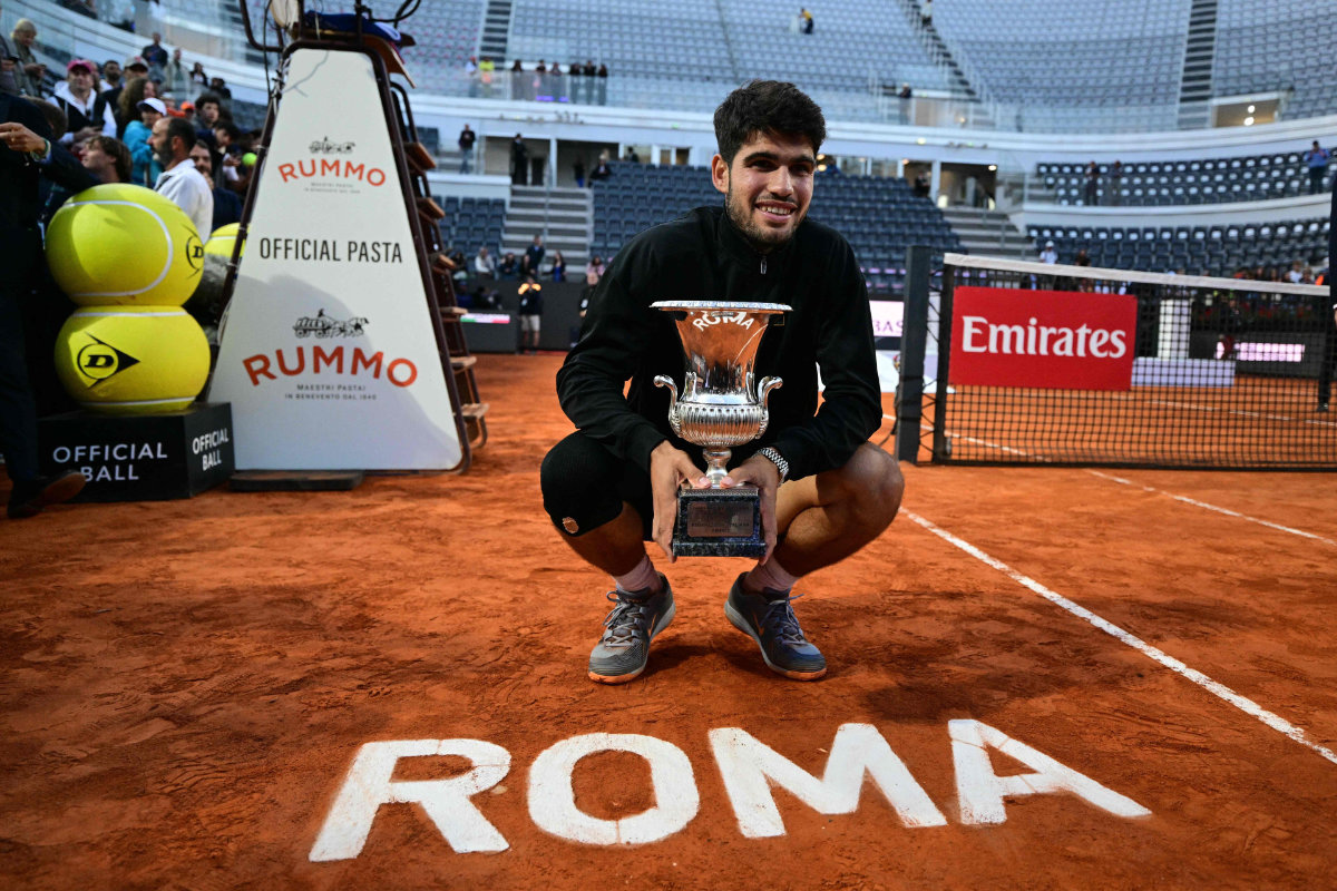 Spain’s Carlos Alcaraz poses with the champion trophy at the end of his men’s singles final match against Italy’s Jannik Sinner at the ATP Rome Open tennis tournament at Foro Italico in Rome on Sunday. (AFP)