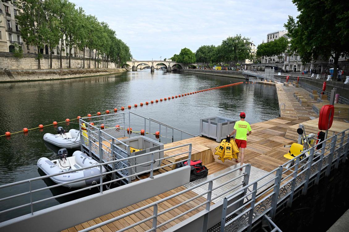 A lifeguard sets up gear at the Pont Marie safe bathing site on the River Seine on its opening day in Paris on July 5, 2025. (AFP)