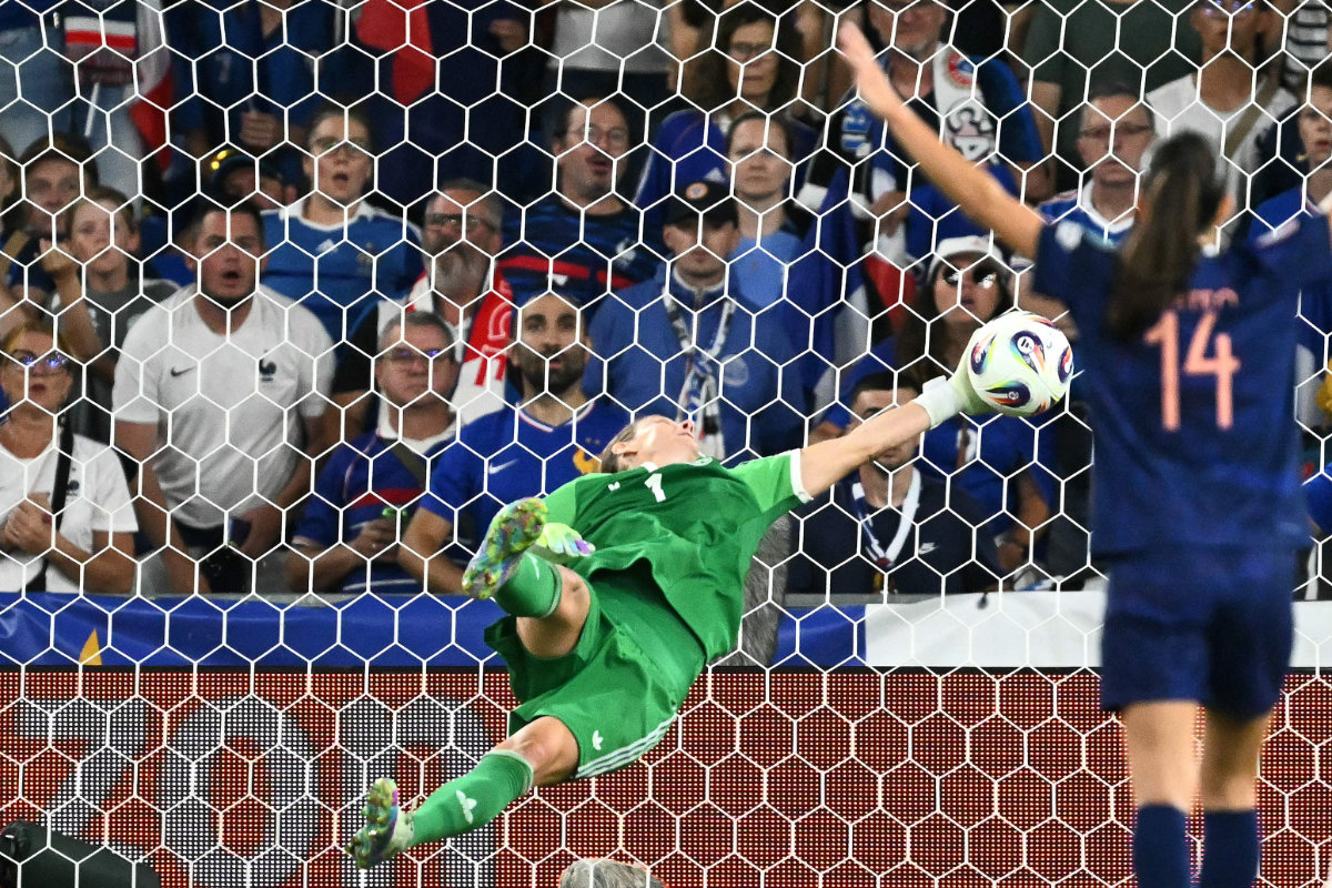 Germany's goalkeeper Ann-Katrin Berger dives to stop the ball during the UEFA Women's Euro 2025 quarter finals football match between France and Germany at the Parc Saint-Jacques stadium in Basel, Switzerland, on July 19, 2025. (AFP)