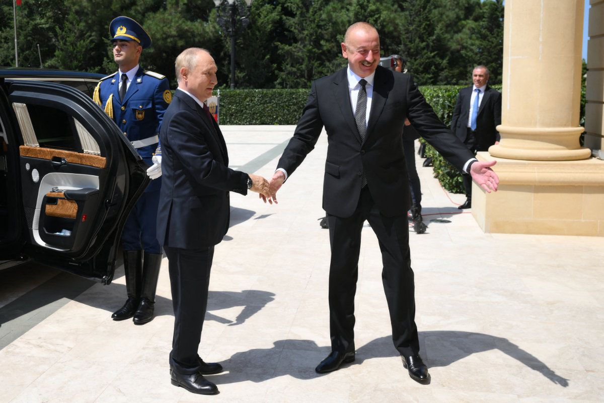 Azerbaijan's President Aliyev (R) welcomes Russia's President Putin to Baku on Aug. 19, 2024. (Pool/Sputnik via AFP)