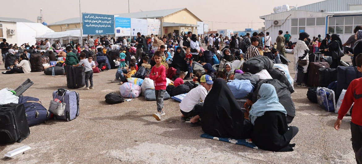 Afghan families deported from Iran gather at a border crossing in Herat province, Afghanistan. (Photo courtesy of UNHCR)