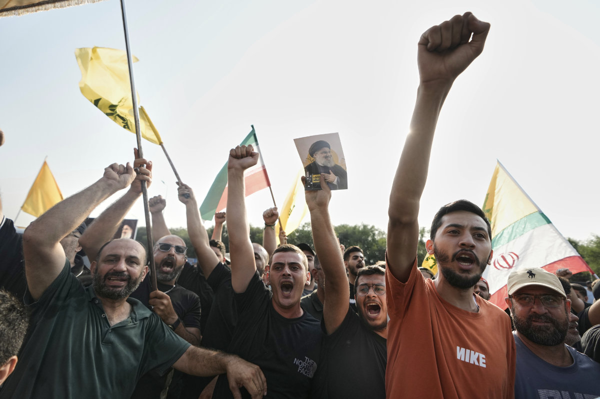 Hezbollah supporters welcome Iran's National Security Council head Ali Larijani outside Beirut's airport on Aug. 13, 2025. (AP)