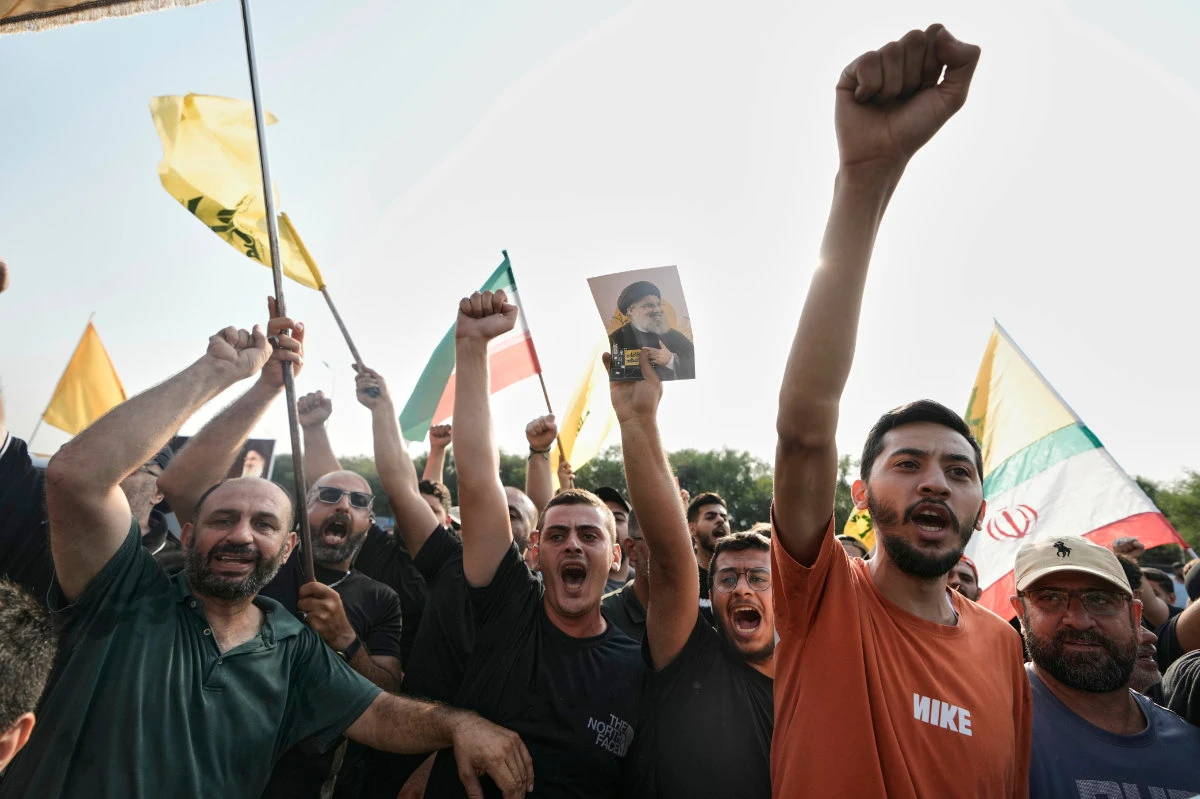 Hezbollah supporters welcome Iran's National Security Council head Ali Larijani outside Beirut's airport on Aug. 13, 2025. (AP)