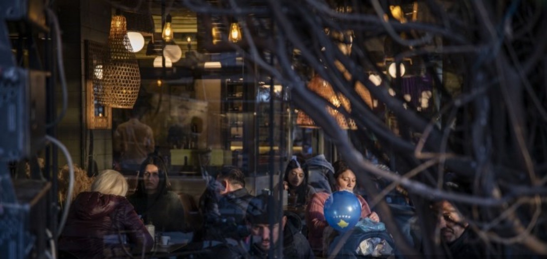 People enjoy their coffee in a cafe in downtown Prishtina, Kosovo. (AFP)