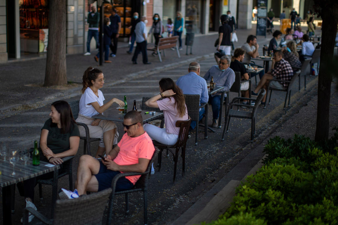 Customers sit at a terrace bar in Girona, Spain, on May 18, 2020. (AP/File)