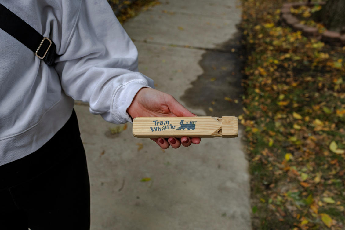 A woman holds a whistle she uses to alert others about the presence of federal agents during immigration raids, in Chicago, Illinois, US, October 21, 2025. (REUTERS)
