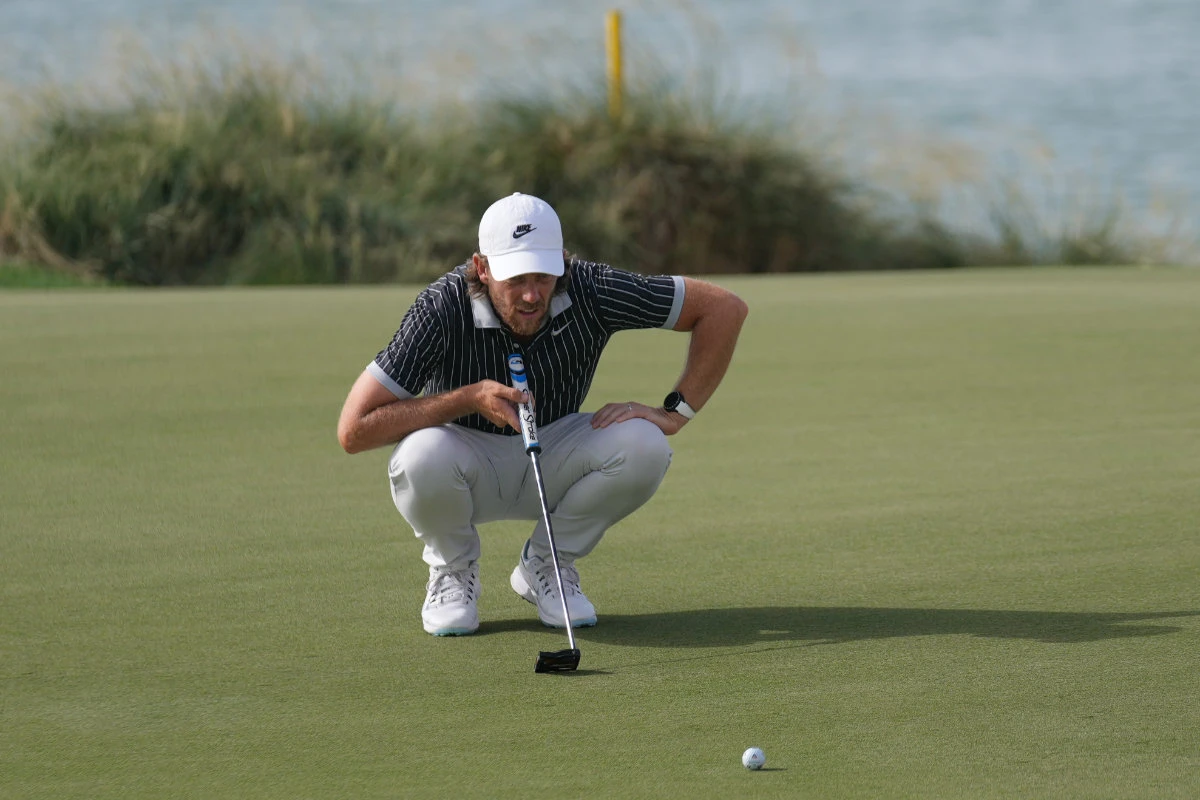 Tommy Fleetwood of England lines up a putt on the 17th green during the second round of Abu Dhabi Golf Championship in Abu Dhabi, UAE, Friday. (AP)