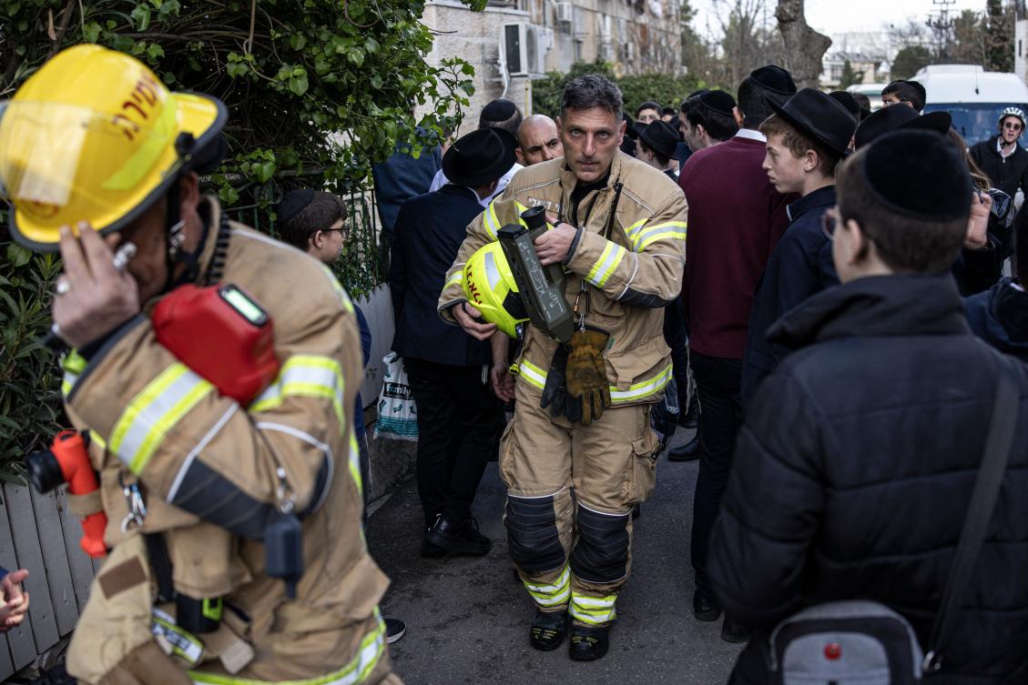 A firefighter leaves the site of an incident which killed two babies at a day care in Jerusalem on Monday. (AFP)