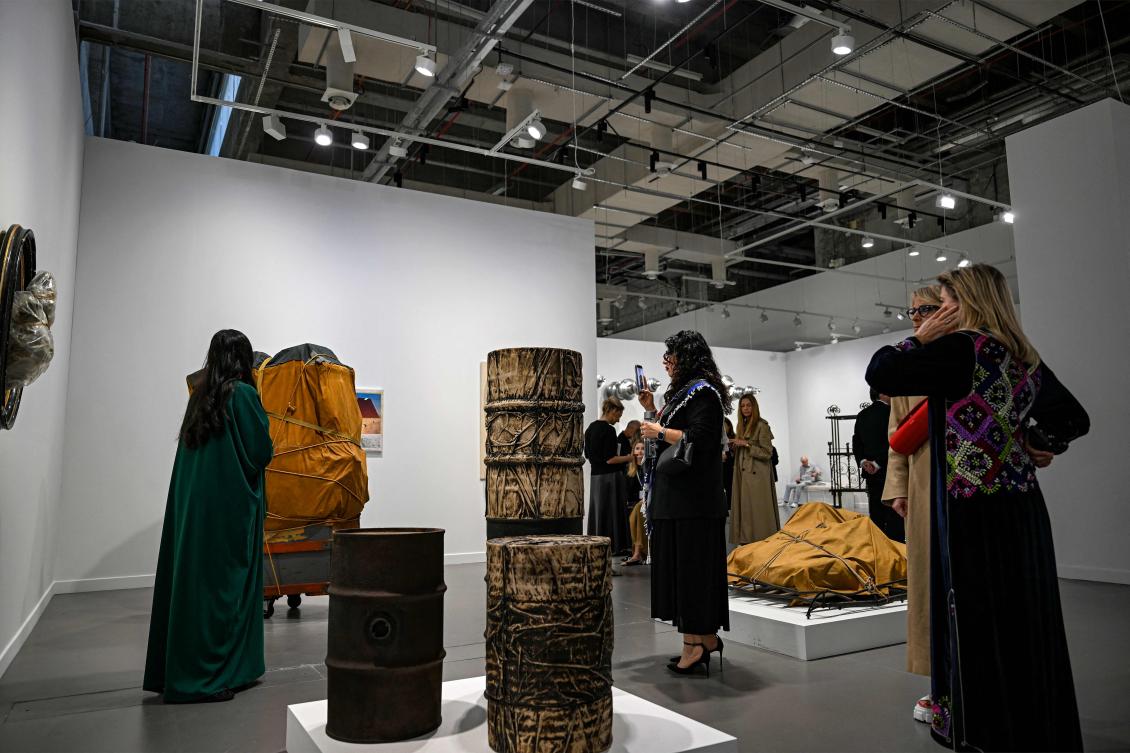 Visitors tour during a presentation of early sculptural works of Bulgarian artist Christo Vladimirov Javacheff from the late 1950s and early 1960s during the inaugural edition of Art Basel Qatar in Doha February 3, 2026. Mahmud Hams / AFP)