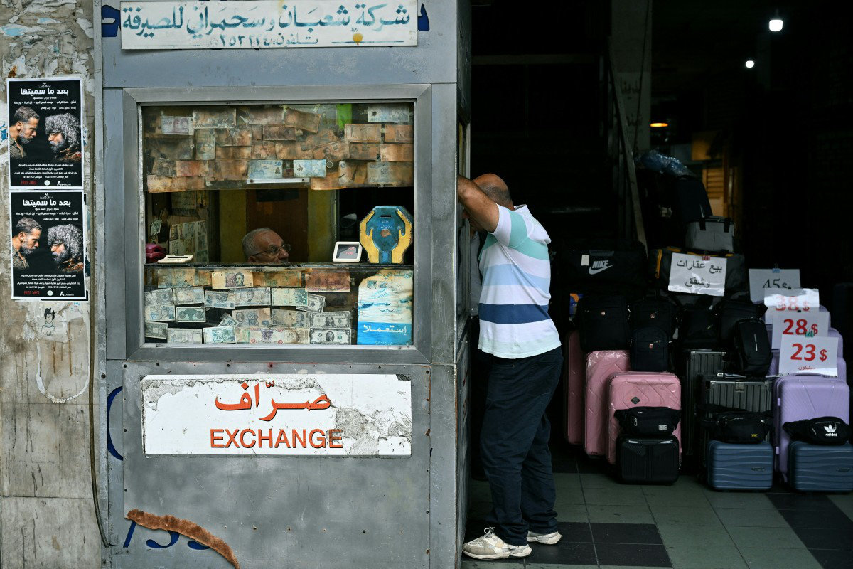 A client stands at a money exchange office in Beirut on November 14, 2025. (AFP)