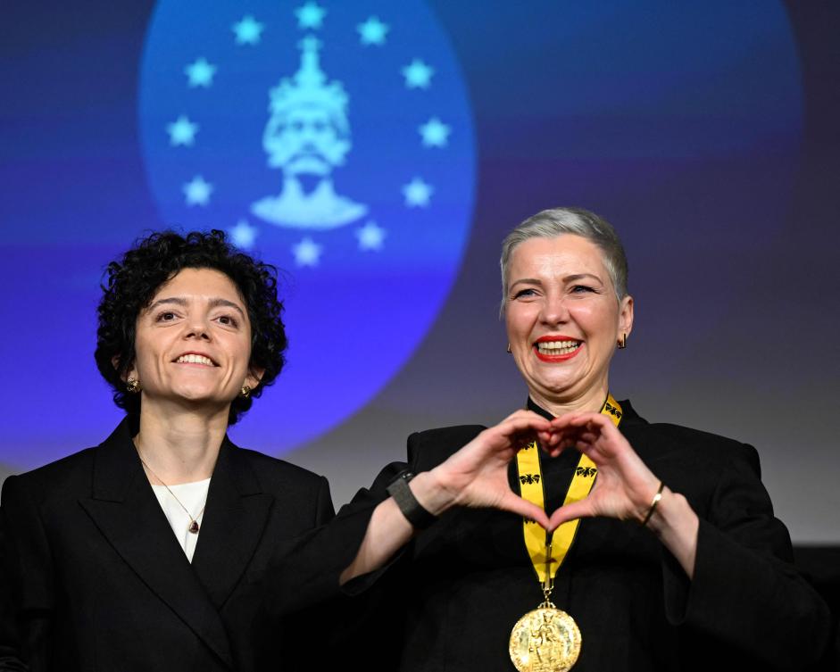 Belarusian street protest leader Maria Kolesnikova (R) gestures next to her sister Tatiana Khomich after having been awarded with the 2022 International Charlemagne Prize of Aachen (Karlspreis) during a ceremony at the Coronation Hall of the Town Hall in Aachen, western Germany on Mar. 14, 2026. (AFP)