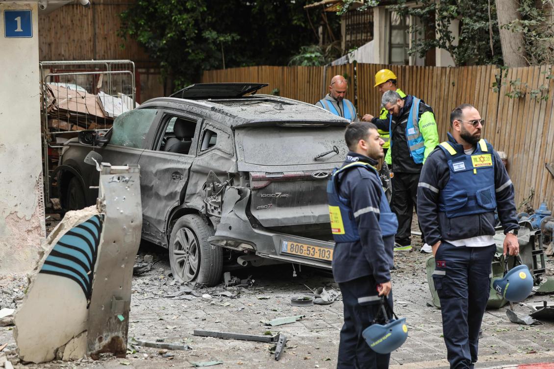 Israeli security forces and first responders work at the site of an impact in a residential neighbourhood of Tel Aviv following an Iranian strike on Wednesday. (AFP)