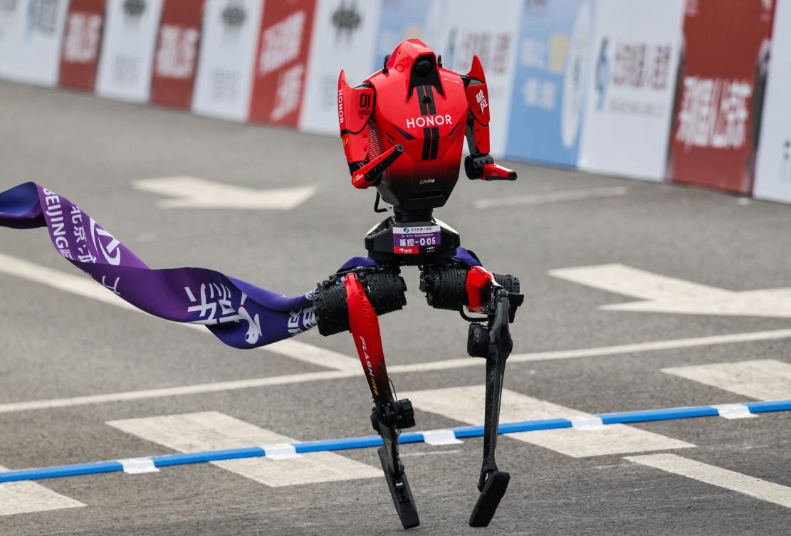 A Lightning humanoid robot by Honor crosses the finish line of the second Beijing E-Town Half Marathon and Humanoid Robot Half Marathon in Beijing, China April 19, 2026. (Reuters)