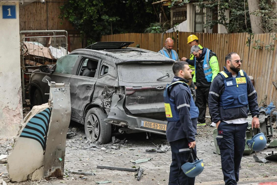 Israeli security forces and first responders work at the site of an impact in a residential neighbourhood of Tel Aviv following an Iranian strike on Wednesday. (AFP)