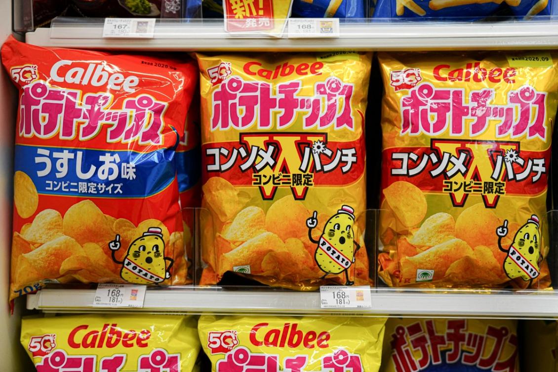 Bags of Calbee potato crisps are seen at a convenience store in Tokyo on May 12, 2026. (File/AFP)