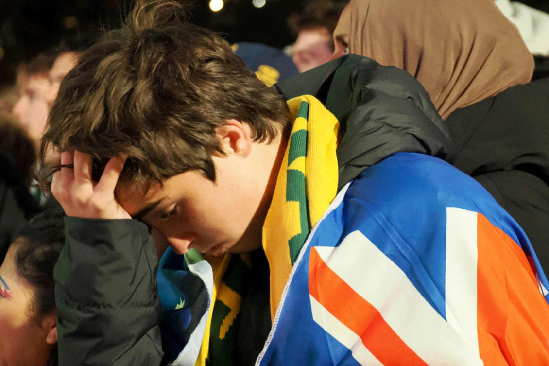 An Australian fan reacts as they watch a broadcast of the World Cup 2026 Group D match between Australia and the United States at Tumbling Park in Sydney on June 20, 2026. (AFP)