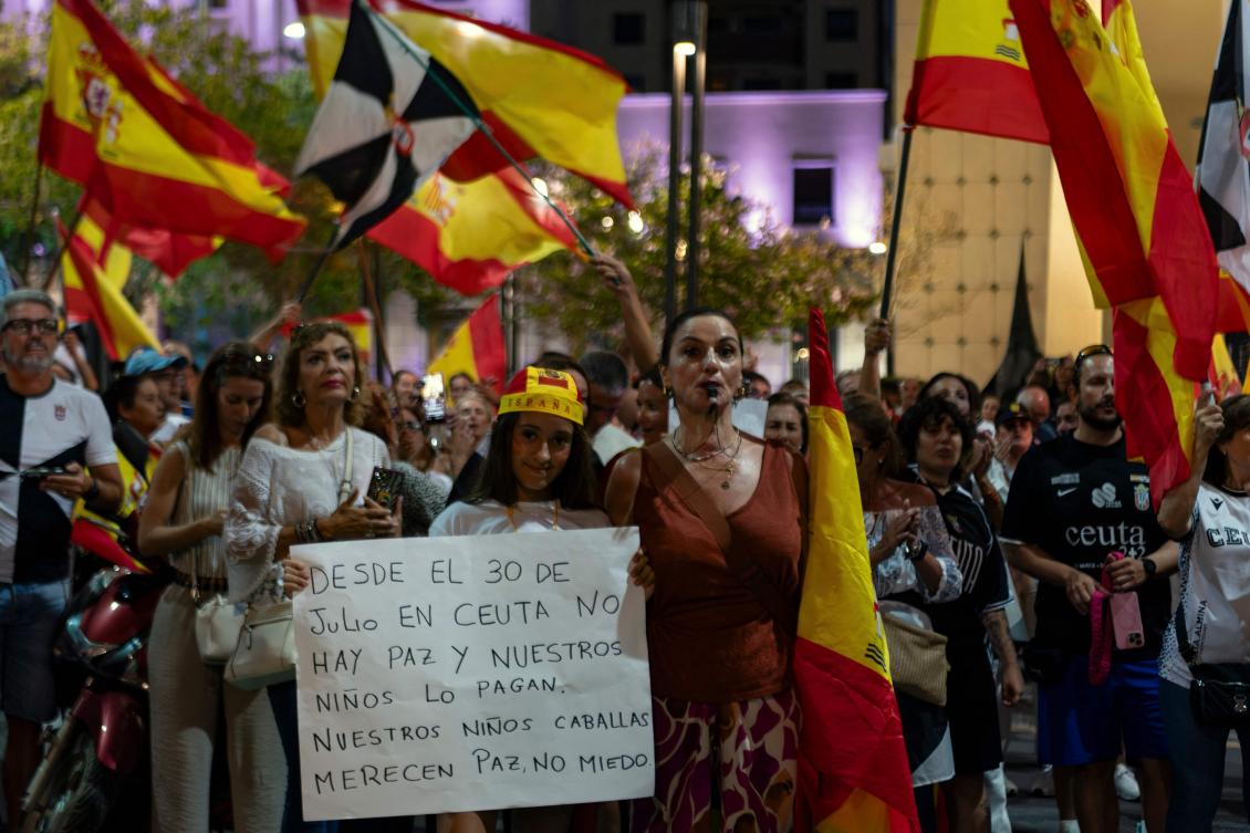 Residents carrying Spanish flags take part in a protest demanding government action to restore normality in the city and calling for the resignation of Spanish Prime Minister Pedro Sanchez, in the North African Spanish city of Ceuta, on August 30, 2026. (AFP)