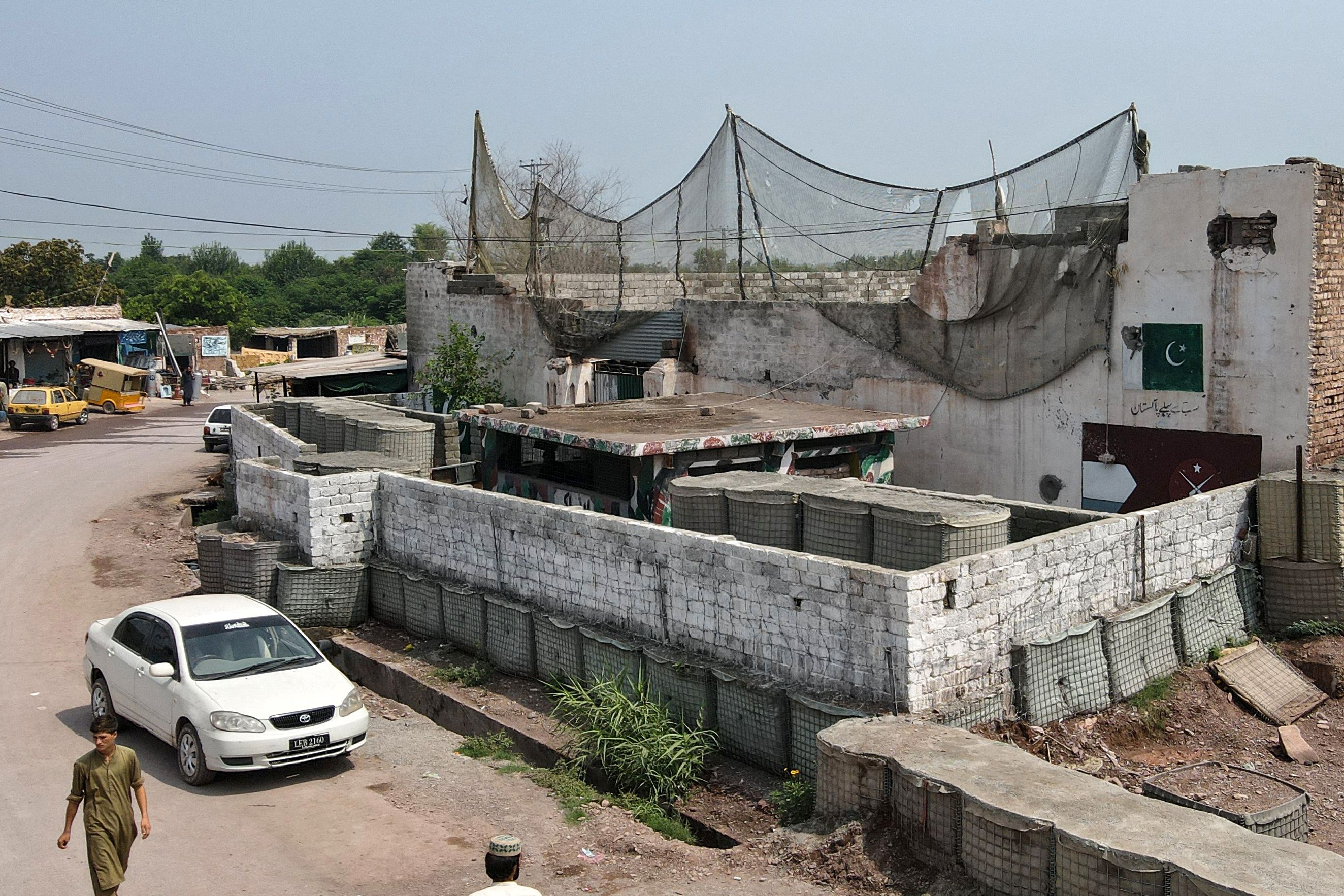 This aerial photograph taken on August 4, 2026, shows a police post fortified with mesh barriers and a newly built boundary wall, serving as a defense against militant drone attacks in Bara, Khyber Pakhtunkhwa province, Pakistan. (AFP)