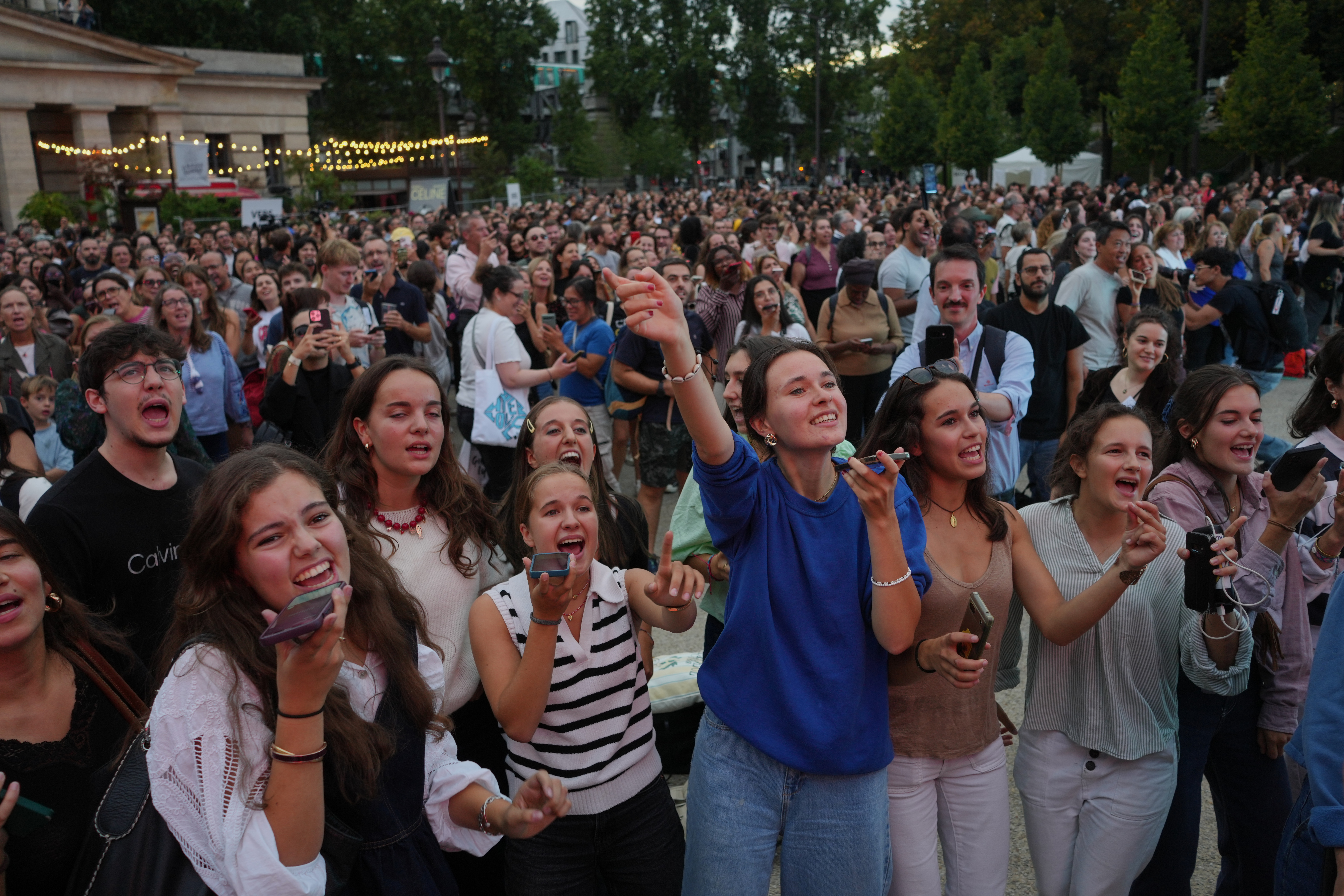 People participate in a karaoke session featuring Celine Dion's songs, the night before her first concert in Paris, Friday, Sept. 11, 2026. (AP)