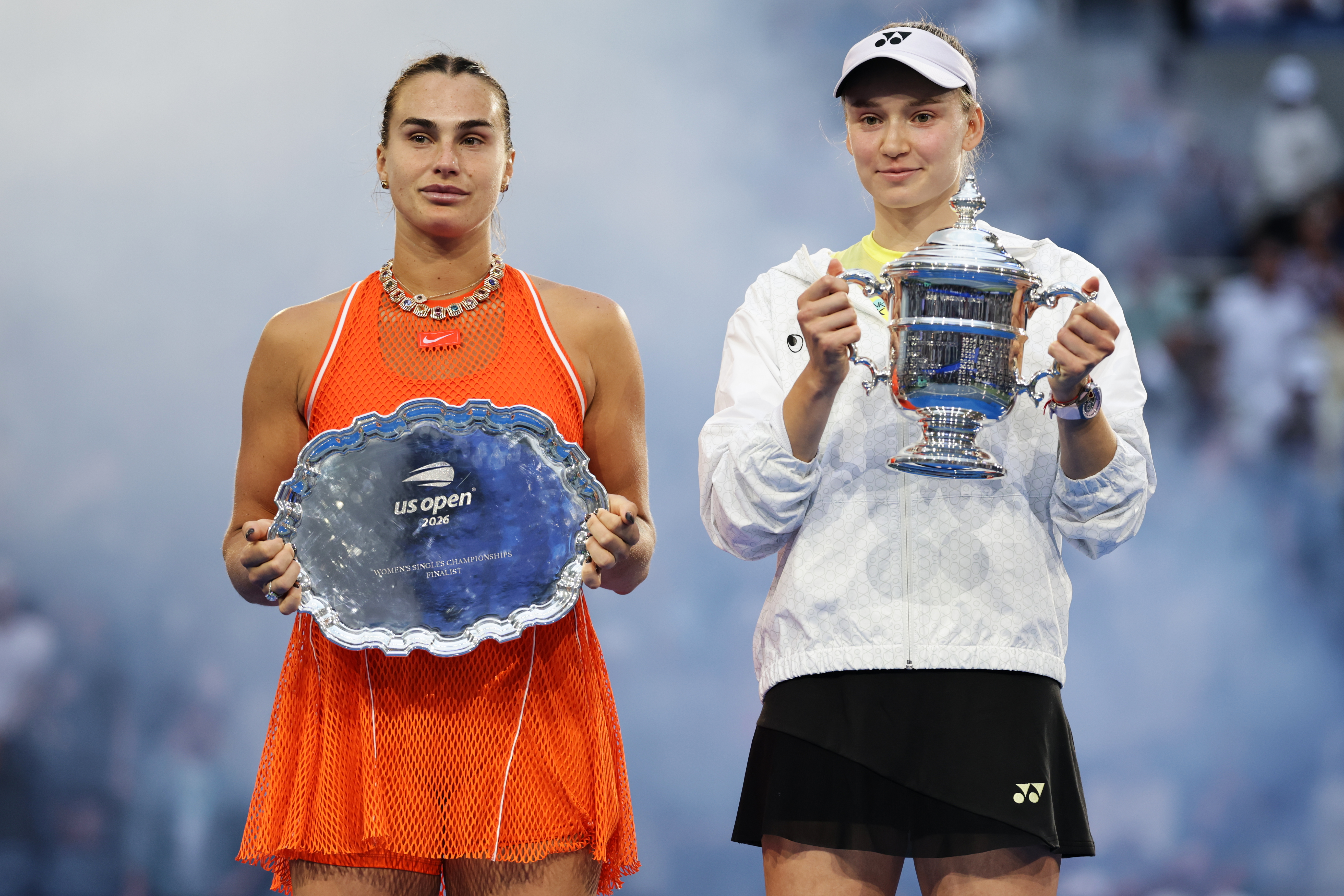 Aryna Sabalenka, of Belarus, left, and Elena Rybakina, of Kazakhstan, right, hold up their trophies after Rybakina won the women's singles final of the US Open tennis championships Saturday, Sept. 12, 2026, in New York. (AP)