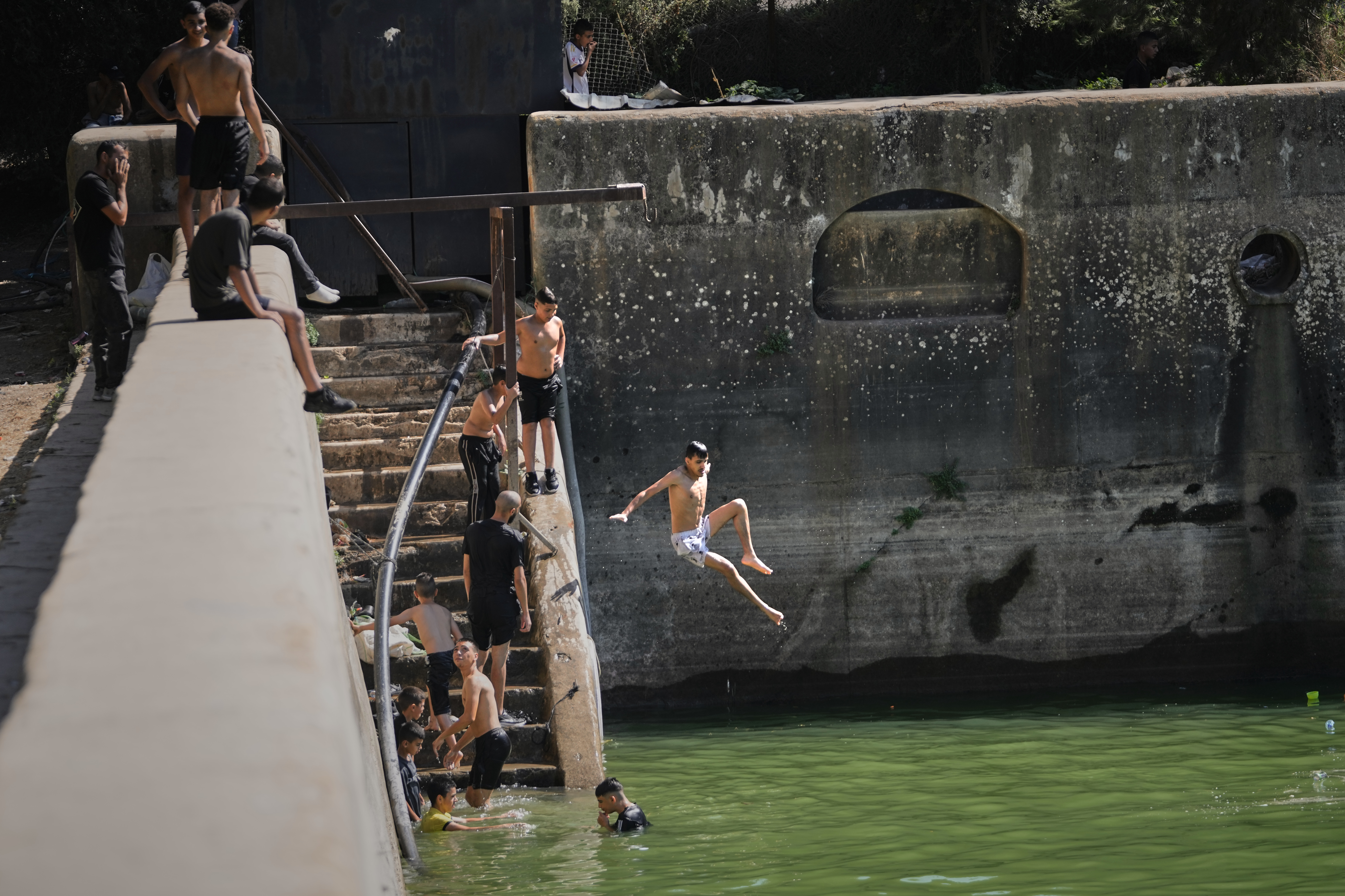 Palestinians cool off at the site of Solomon's Pools, an ancient water reservoirs located south of the West Bank city of Bethlehem.