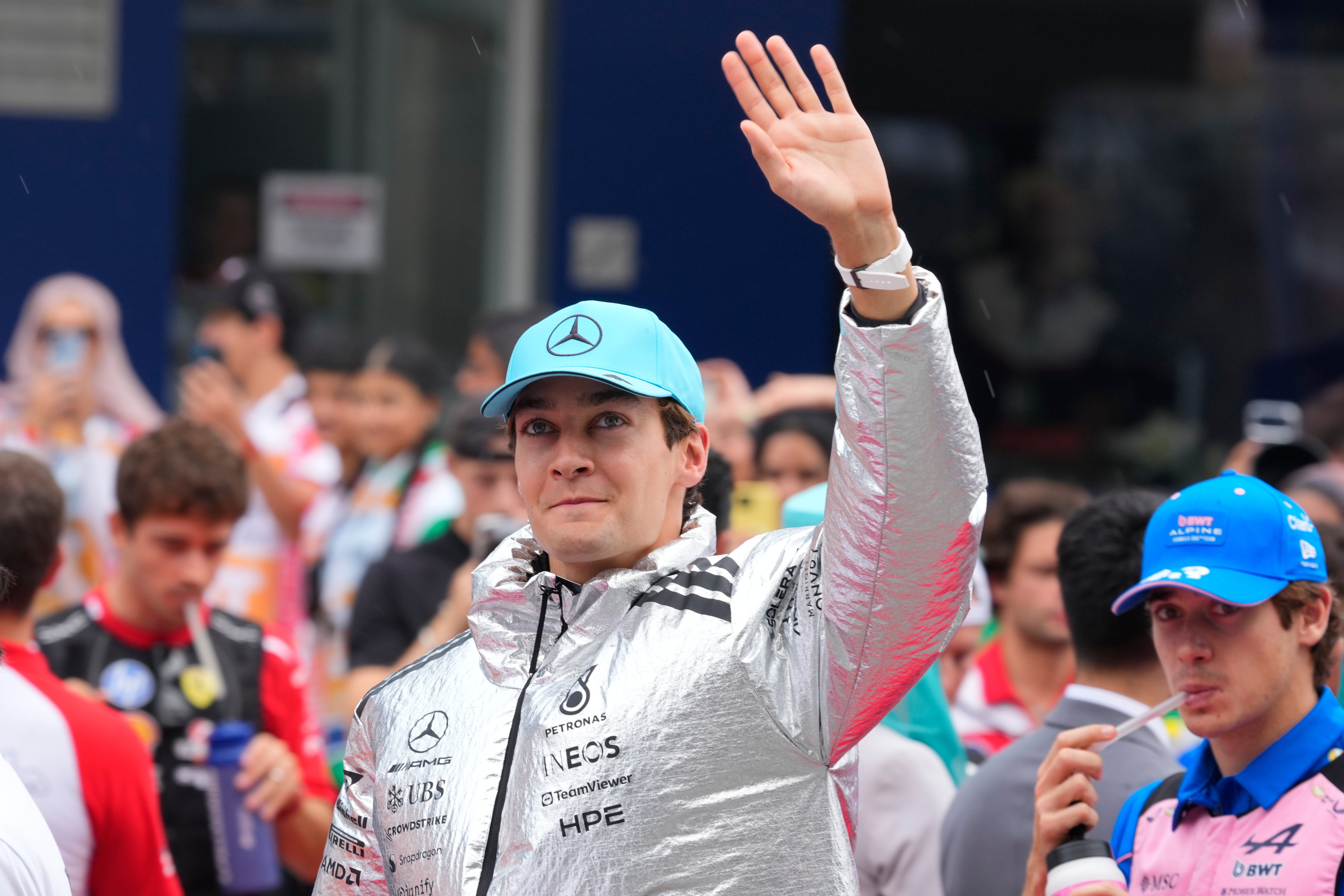 Mercedes driver George Russell of Britain waves to spectators during a drivers' parade ahead of the Bahrain Grand Prix in Sepang, Malaysia, Sunday, Oct. 4, 2026. (AP Photo/Vincent Thian)
