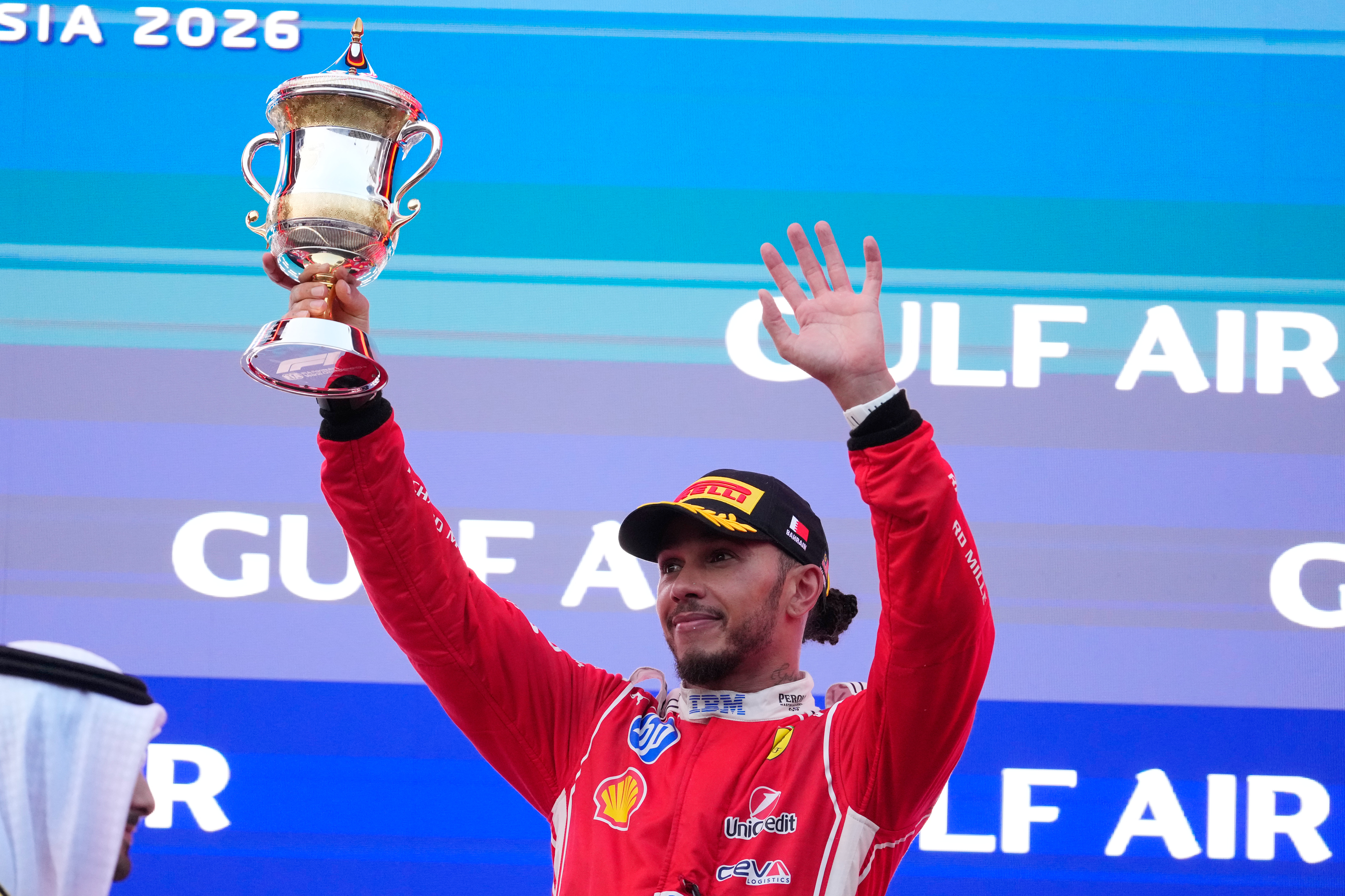 Ferrari driver Lewis Hamilton of Britain celebrates his third place on the podium the Bahrain Grand Prix in Sepang, Malaysia, Sunday, Oct. 4, 2026. (AP Photo/Vincent Thian)