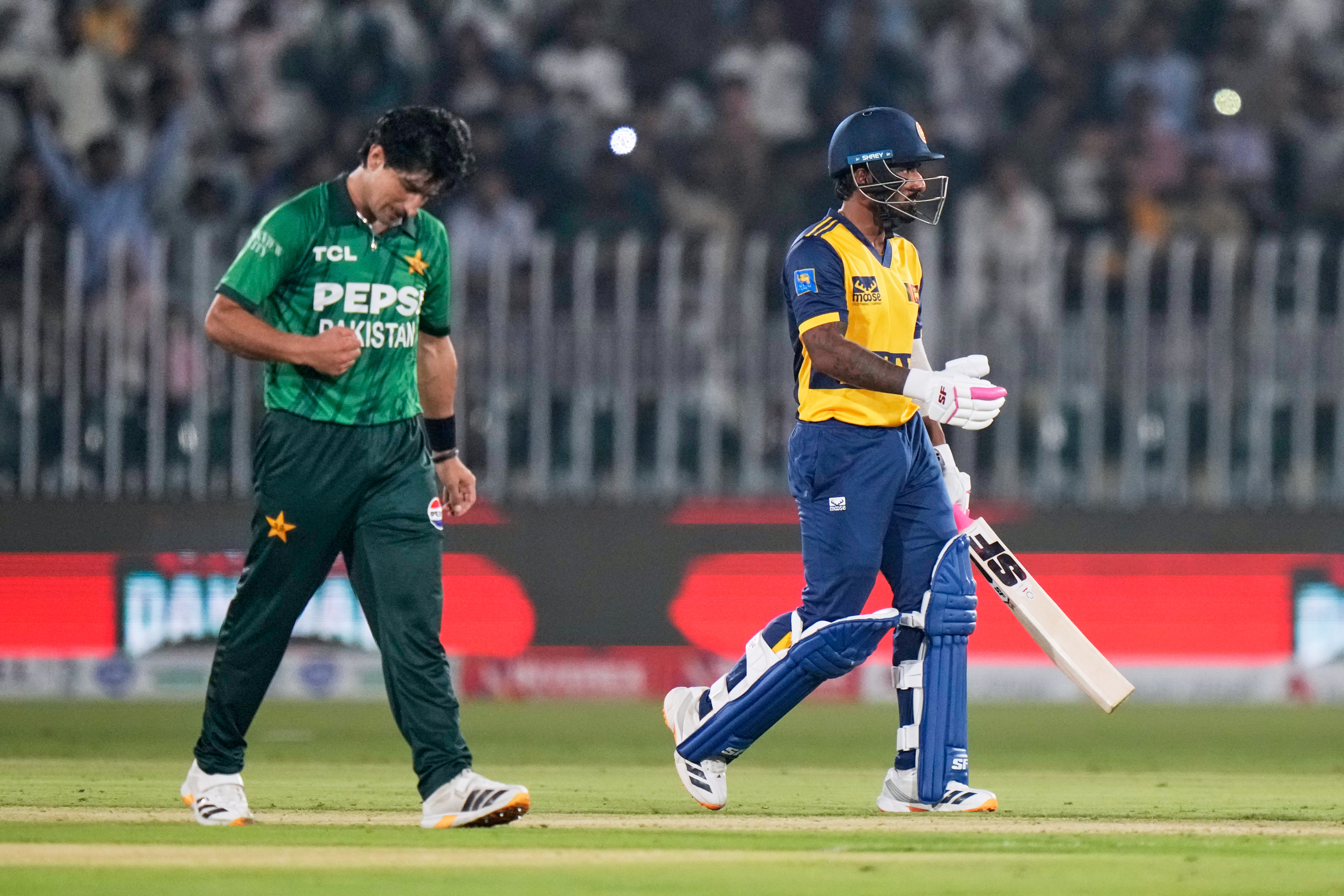 Pakistan’s Naseem Shah celebrates after taking the wicket of Sri Lanka’s Dunith Wellalage (right) during the first T20 cricket match between Pakistan and Sri Lanka, in Rawalpindi, Pakistan, October 9, 2026. (AP)