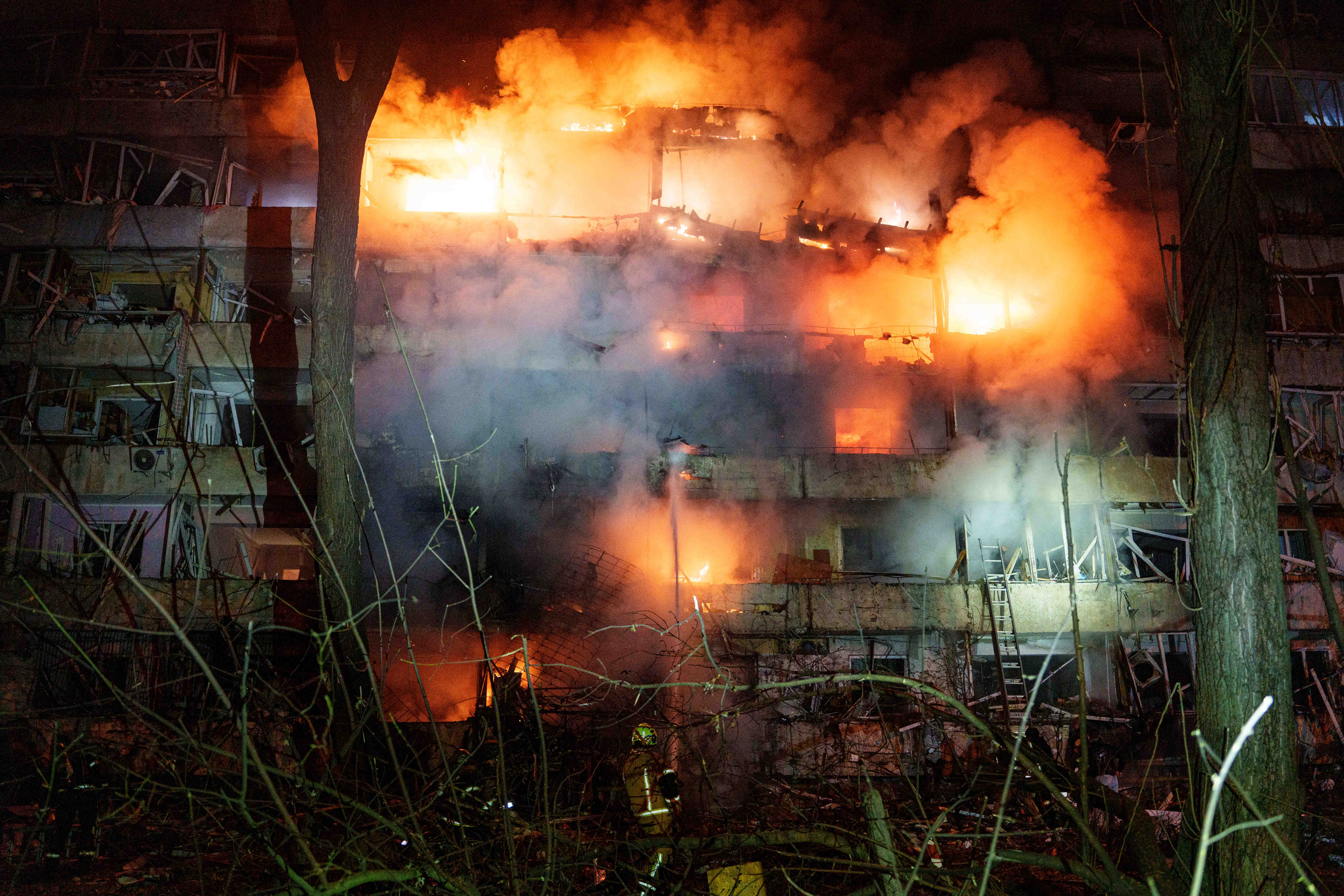 A damaged multi-story residential building is seen on fire after a Russian missile strike on Kyiv, Ukraine, on Tuesday.