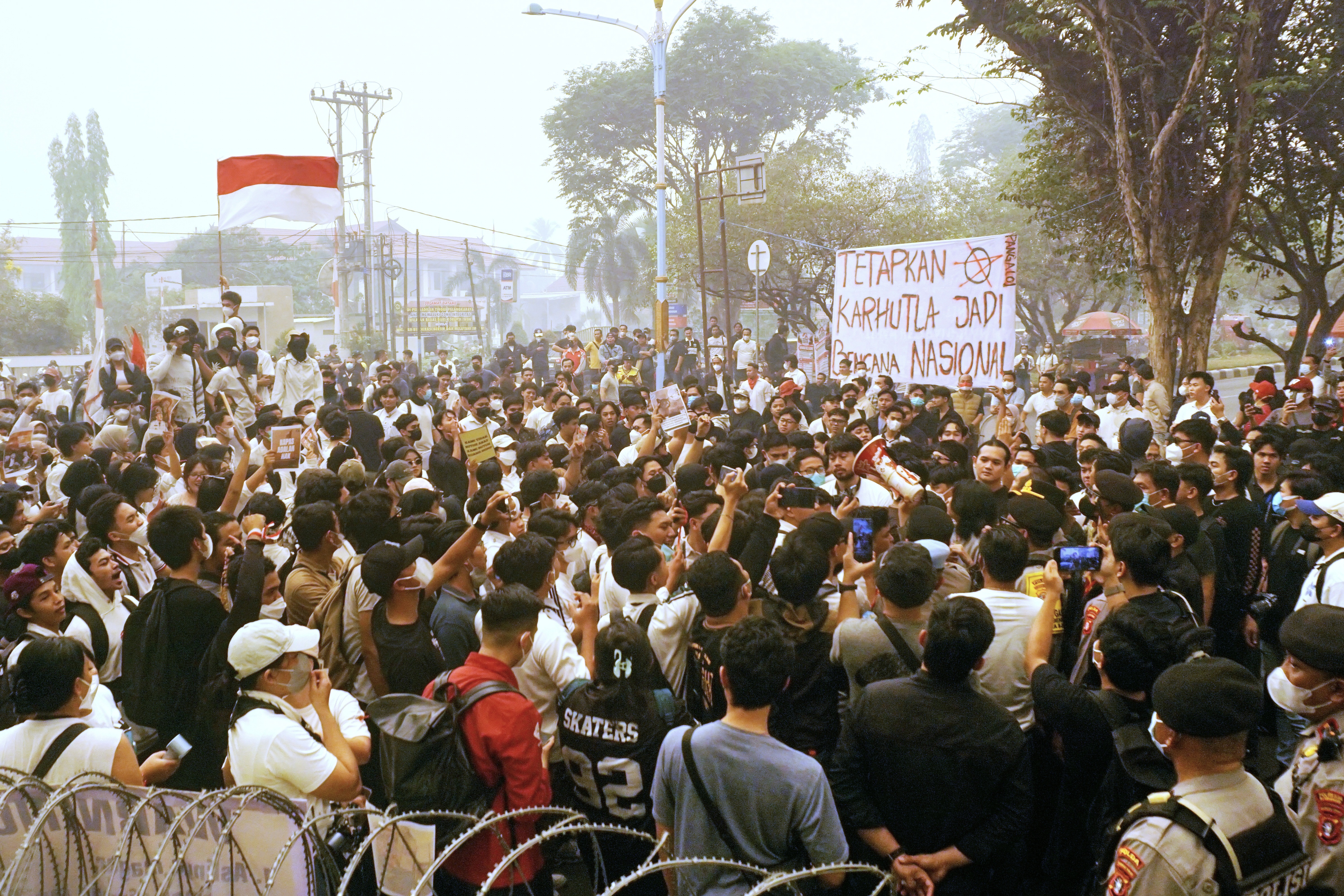 ‘How is it possible?': Students protest Indonesian haze